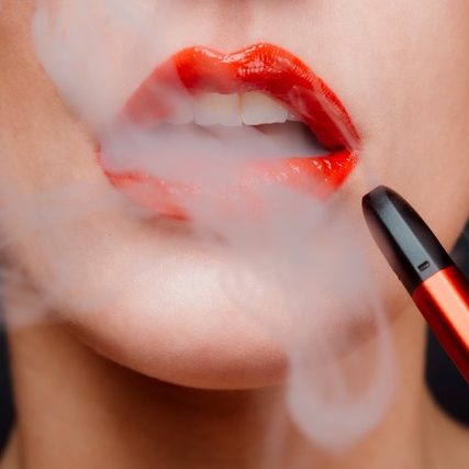 woman with red lipstick vaping